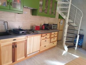 a kitchen with a spiral staircase in a kitchen at Independent Old House in Gozo With Modernized Interior in Munxar