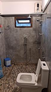 a bathroom with a shower and a toilet and a sink at Taco Super Place in Unawatuna +14 photos