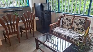 a living room with a couch and chairs and a table at Taco Kings Place in Unawatuna