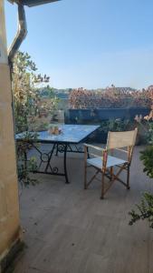 a table and a chair sitting on a patio at Independent Old House in Gozo With Modernized Interior in Munxar