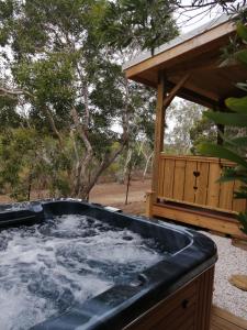 a hot tub in a backyard with a gazebo at NIAOULI LODGE in Bourail