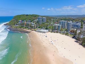 an aerial view of a beach with people on it at Burleigh Beach Tower in Gold Coast