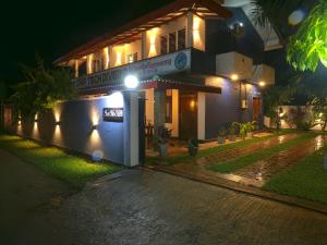 a house with lights on the side of it at night at Sea View Villa in Hikkaduwa