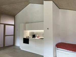 a kitchen with white cabinets and a red counter top at Apartamento MENDEBALDE 