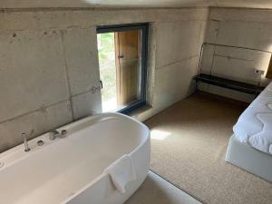 a white bath tub in a room with a window at Apartamento MENDEBALDE 