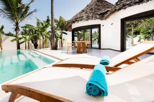 a rental villa with a swimming pool at Blue Moon Resort in Jambiani