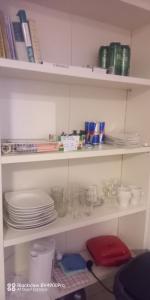 a shelf with plates and bowls and dishes on it at Villa Fortuna Budget in Lackenhof