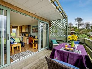 a patio with a table with a purple table cloth at 1 Bed in Aberdovey 91692 in Pennal