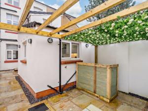 an open garage with a pergola and a building at 4 Bed in Fleetwood 91701 in Fleetwood
