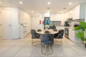 a kitchen with a dining table and chairs at FAM Living - Rahaal 1BR Bliss in Madinat Jumeirah Living in Dubai