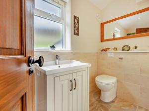 a bathroom with a toilet and a sink and a window at 1 Bed in Matterdale 91812 in Dockray