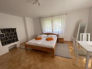 una camera da letto con un letto, un tavolo e una scrivania di Haus Linsendorf a Gallizien