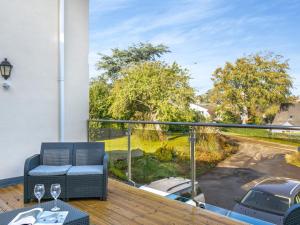 a balcony with a couch and a view of a street at 4 Bed in Westward Ho 91814 in Northam