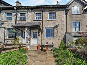 an old stone house with a table in front of it at 3 Bed in Kendal 91839 in Kendal