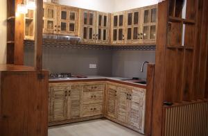 een keuken met houten kasten en een spoelbak bij INAYA VILLA in Amed