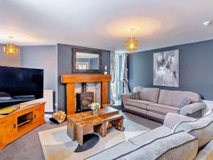 a living room with a couch and a fireplace at 3 Bed in Harrogate 92158 in Harrogate