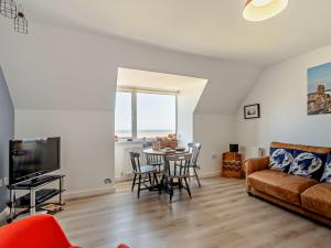 a living room with a couch and a table at 2 Bed in Hornsea 91997 in Hornsea