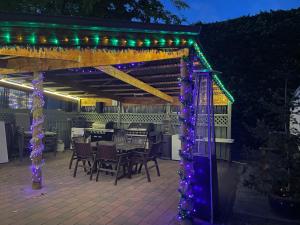 a pergola with lights on a patio at Alexandra Motor Lodge NZ in Alexandra