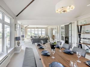 a dining room with a table with wine glasses on it at 5 Bed in Westward Ho 91772 in Bideford