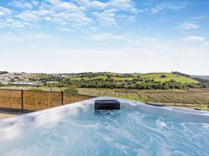 a hot tub with a view of the countryside at 5 Bed in Westward Ho 91772 in Bideford
