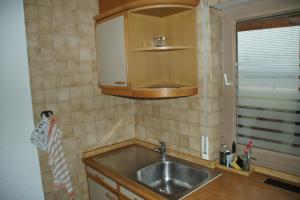 a small kitchen with a sink and a cabinet at RuheOase Oberriexingen - Wohlfühlen, abschalten und entspannen in Oberriexingen +23 photos