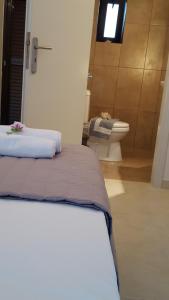 a bedroom with a bed and a toilet in a room at Wester Sun new apartment near Balos & Falassarna in Kissamos