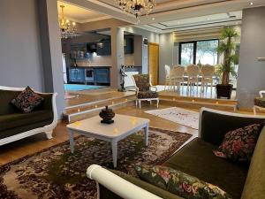 a living room with a couch and a table and a kitchen at LİFOZ Holiday resort in Trabzon