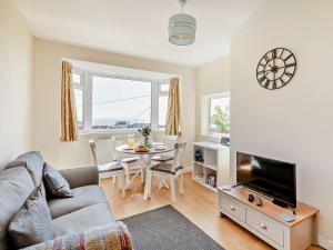 a living room with a couch and a table at 2 Bed in Paignton 92055 in Paignton