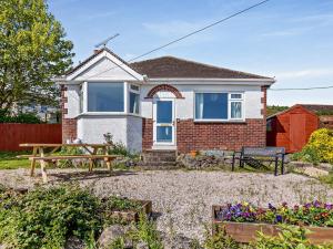 a house with a bench in the yard at 2 Bed in Paignton 92055 in Paignton