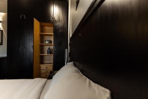 a bedroom with a bed and a black wall at Assiut Cement Hotel in Asyut