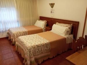 a hotel room with two beds and a window at Hospedaje Magallanes in Santander