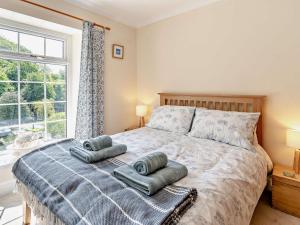 a bedroom with a bed with two pillows on it at 3 Bed in Swansea 92059 in Sketty