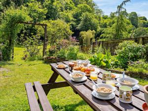 a picnic table with food on it in a garden at 3 Bed in Swansea 92059 in Sketty