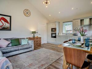 a living room with a couch a table and a kitchen at 3 Bed in Gower 91721 