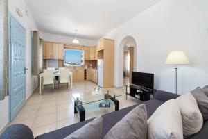 a living room with a couch and a table at Ann-Margo House in Fira +5 photos