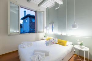 En eller flere senge i et værelse på Everyday Apartments Torre Medioevale