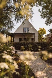 a house is seen through the leaves of trees at De Durgerdam, Amsterdam in Amsterdam