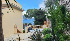 a house with a patio and a view of the ocean at Hôtel de Charme Brise Marine in Saint-Jean-Cap-Ferrat