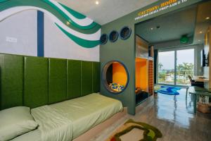a room with a bed and a round mirror at Solea Mactan Resort and Waterpark in Mactan