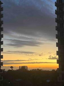 a view of the sunset from a window of a building at Ross' Cosy Corner in Lapu Lapu City