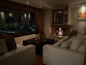 a living room with a couch and a fire place at sunlight loft in Kastoria