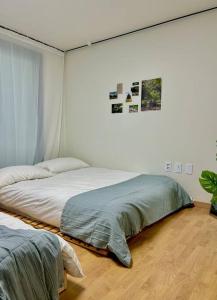 a bedroom with two beds in a room at Raon house in Suwon