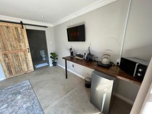 a kitchen with a wooden counter and a microwave at The Guesthouse Kokstad in Kokstad