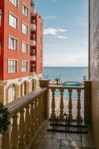 a balcony with a view of the ocean at Apartment Complex Rich in Nesebar