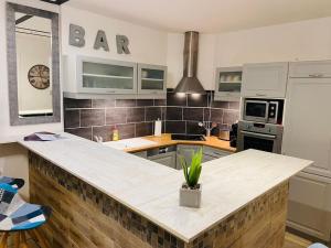 a kitchen with a large island in the middle at Appartement Collioure centre & GARAGE PRIVATIF in Collioure