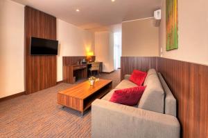a living room with a couch and a table at Congress Hotel Centrum in Košice +11 photos