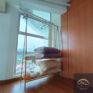 a iron bed with pillows in a room with a window at Minimalist Duplex @ BayanLepas in Bayan Lepas +36 photos