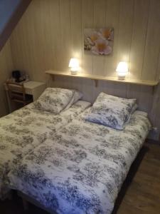 a bedroom with a bed with two pillows on it at LA CLIMONTAINE in Urbeis