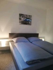 a bedroom with a blue bed with a blue car on the wall at Boxenstopp in der Vulkaneifel in Boos