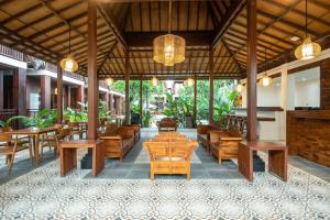 a restaurant with wooden tables and chairs and lights at DADEKA Canggu in Canggu
